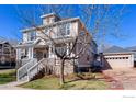 Charming two-story home with a stone facade, inviting front porch, and a detached garage at 4921 Fountain St, Boulder, CO 80304
