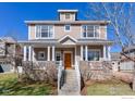Inviting two-story home with a covered front porch, stone accents, and well-maintained landscaping at 4921 Fountain St, Boulder, CO 80304