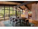 Dining room with an expansive window view and modern chandelier above a large table at 705 Willowbrook Rd, Boulder, CO 80302