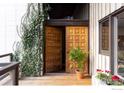 Inviting front entrance with double doors, lush greenery, and charming flower boxes at 705 Willowbrook Rd, Boulder, CO 80302