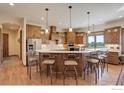 Kitchen with a large central island and countertop seating at 7777 Aggregate Blvd, Erie, CO 80516