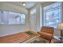 Inviting entryway with laminate floors, ample natural light, and a cozy chair for a welcoming ambiance at 835 Kane Dr # 25, Longmont, CO 80501