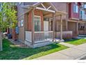 Charming townhome showcasing a well-manicured lawn, brick accents, and a welcoming front porch at 835 Kane Dr # 25, Longmont, CO 80501