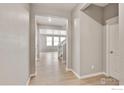 Inviting foyer with hardwood floors and ample natural light from open floor plan at 840 Leeward St, Lochbuie, CO 80603