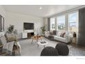 Bright living room with lots of natural light from large windows and modern decor at 840 Leeward St, Lochbuie, CO 80603