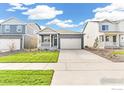 Charming single-story home with well-kept lawn, two-car garage, and an inviting front porch at 852 Leeward St, Lochbuie, CO 80603
