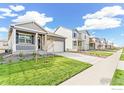 A quiet street featuring similar single Gathering homes with well-kept lawns, driveways, and landscaping at 852 Leeward St, Lochbuie, CO 80603