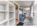 Inviting entryway boasting patterned tile floors, built-in bench, coat hooks, and an open doorway at 1031 N 4Th St, Berthoud, CO 80513
