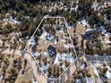 Wide aerial shot displays the property boundaries in a forested environment at 1335 Deer Trail Rd, Boulder, CO 80302