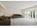Bright and airy living room featuring plush carpeting, bay windows, and comfortable seating arrangements at 1518 Vivian St, Longmont, CO 80501