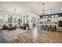 Spacious open concept living room and kitchen with hardwood floors and modern lighting at 16392 Spanish Peak Way, Broomfield, CO 80023