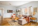 Bright living room boasts hardwood floors, a large window, and a comfortable sectional sofa at 2121 Grove Cir, Boulder, CO 80302