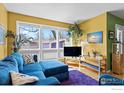 Inviting living room with bright, colorful walls, comfortable seating, and large windows at 2276 Goss Cir, Boulder, CO 80302