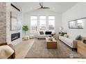 Bright living room with vaulted ceiling, modern fireplace, and large windows showcasing the neighborhood at 2341 Feathergrass Ln, Superior, CO 80027