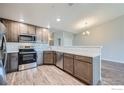 Well-lit modern kitchen with stainless steel appliances and light-toned cabinets at 2435 Calais Dr # A, Longmont, CO 80504