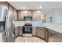 Well-lit modern kitchen with stainless steel appliances and light-toned cabinets at 2435 Calais Dr # A, Longmont, CO 80504
