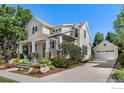 Exterior elevation of a well-maintained home showcasing a spacious driveway and detached garage at 245 Spruce St, Louisville, CO 80027