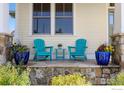 Inviting front porch with stone accents, featuring seating and potted plants for a cozy and charming entrance at 245 Spruce St, Louisville, CO 80027