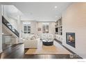 Inviting living room features a modern fireplace, built-ins, and sleek glass staircase at 2826 Broadway St # 106, Boulder, CO 80304