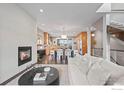 Open-concept living room showcases a fireplace, kitchen, and modern furnishings at 2826 Broadway St # 106, Boulder, CO 80304