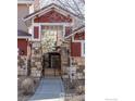 Elegant gated entrance with stone columns and lush greenery visible beyond at 3488 Molly Cir, Broomfield, CO 80023