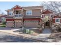 Lovely townhome showcases multiple garages, a balcony, and stone details at 3488 Molly Cir, Broomfield, CO 80023