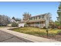 Inviting two-story house with solar panels, a spacious front porch, and landscaped front yard at 357 W Harper St, Louisville, CO 80027