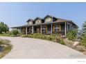 Beautiful blue two-story home with a long driveway and inviting, expansive front porch at 3967 Eastout Ave, Parker, CO 80138