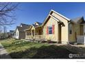 Street view of well-maintained homes with manicured lawns under a clear blue sky at 4215 Bella Vista Dr, Longmont, CO 80503