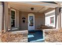 Inviting front porch featuring a classic porch swing and neutral tones at 4337 Umatilla St, Denver, CO 80211