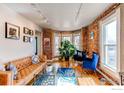 Cozy living room features exposed brick, large windows, and stylish furnishings at 4337 Umatilla St, Denver, CO 80211