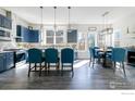 Bright kitchen features stylish blue cabinetry, stainless appliances, a large island, and a charming breakfast nook at 438 Meridian Ln, Superior, CO 80027