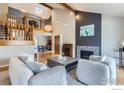 Open living room featuring high ceilings, fireplace, and hardwood floors, with stairs to a loft area at 5275 Holmes Pl, Boulder, CO 80303