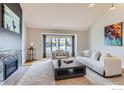 Bright living room with a fireplace, neutral tones, and large windows at 5275 Holmes Pl, Boulder, CO 80303