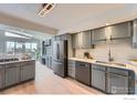 Bright kitchen featuring stainless steel appliances, sleek countertops, and ample cabinet space at 5855 Rustic Knolls Dr, Boulder, CO 80301