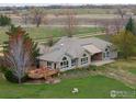 Back exterior showcasing a wooden deck and large windows for natural light at 7940 Valmont Rd, Boulder, CO 80301