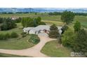 Charming single-story home surrounded by mature trees with well-maintained lawn at 7940 Valmont Rd, Boulder, CO 80301