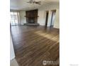Spacious living room with wood-style flooring and a cozy fireplace at 809 Flamingo Cv, Lafayette, CO 80026