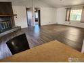 Bright living room featuring wood-style floors and a rustic fireplace at 809 Flamingo Cv, Lafayette, CO 80026