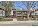 Pleasant home featuring a front porch and well-maintained lawn at 932 Welch Ave, Berthoud, CO 80513