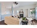Bright living room with a cozy fireplace, stylish furnishings and hardwood flooring at 932 Welch Ave, Berthoud, CO 80513