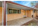 Close up view of a covered porch and entryway to a brick home at 9840 W 41St Ave, Wheat Ridge, CO 80033