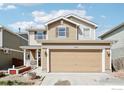 Two-story home featuring neutral toned siding, two car garage and small front porch at 10433 Forester Pl, Longmont, CO 80504