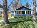Charming blue craftsman home with landscaped front yard and inviting yellow door at 1109 Main St, Louisville, CO 80027