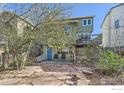 Relaxing backyard featuring a stone patio, a small deck, lush plants, and mature trees at 1149 Quince Ave, Boulder, CO 80304