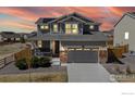 Home's inviting exterior with warm lighting, showcasing its curb appeal and design at 13485 Niagara St, Thornton, CO 80602
