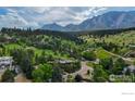 Scenic aerial view of a mountain community featuring a charming home nestled among mature trees at 1420 Sierra Dr, Boulder, CO 80302