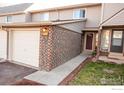 Townhome exterior features brick detail, neutral siding, and a path to the front door at 1634 Centaur Cir, Lafayette, CO 80026