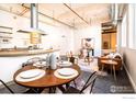 Open-concept dining and living area with modern decor and exposed industrial elements at 1777 E 39Th Ave # 209, Denver, CO 80205