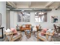 Bright living room with large windows, contemporary furniture, and stylish decor at 1777 E 39Th Ave # 209, Denver, CO 80205